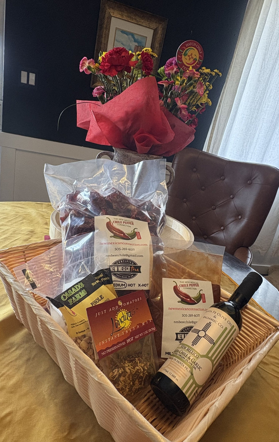 Gift basket contains Chile Pods, NM Olive Oil, Red Chile Powder, Posole and Salsa Mix. 